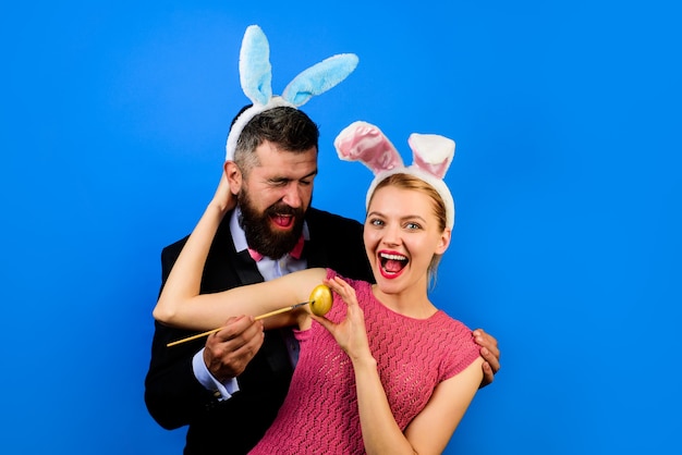 Family celebrate Easter. Happy couple with bunny ears. Happy holidays. Happy couple painting eggs for Easter. Decorating eggs. Holidays. Spring holidays. Season. Bunny ears. Woman with bunny ears.