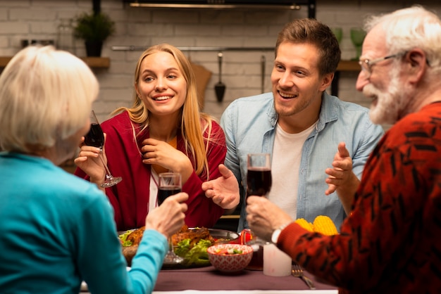 Family chatting and holding glasses of wine