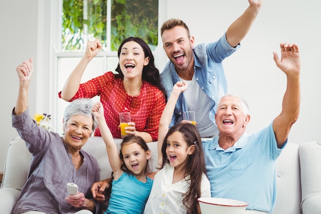 Family cheering while watching television 