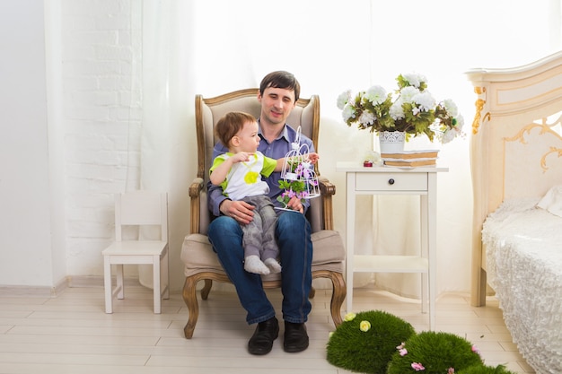 Family, childhood, fatherhood, activity and people concept - happy father and little son playing at home.