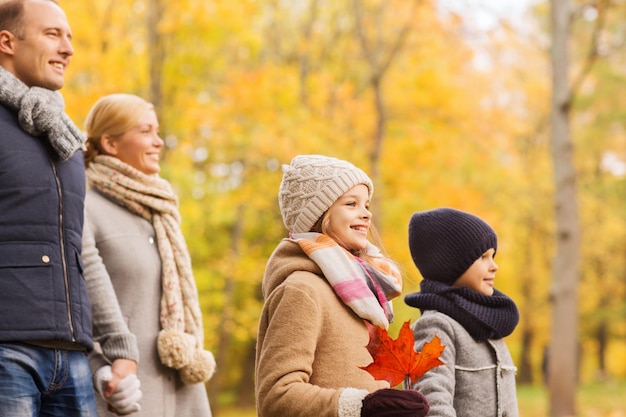 family, childhood, season and people concept - happy family in autumn park