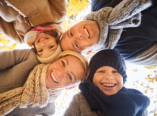 family, childhood, season and people concept - happy family in autumn park