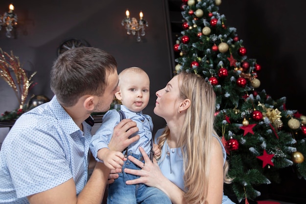 Family at Christmas Mother father and child play against the background