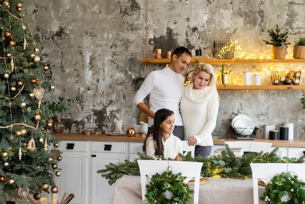 family, christmas, x-mas, winter, happiness and people concept - smiling family preparing for christmas.