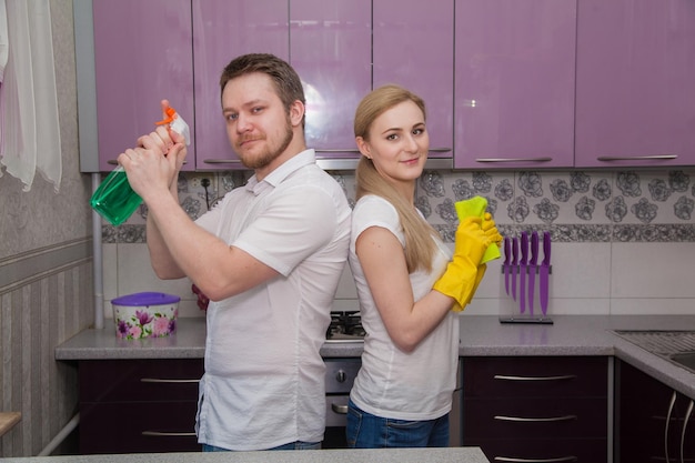 The family cleans up the kitchen Gloves and cleaner