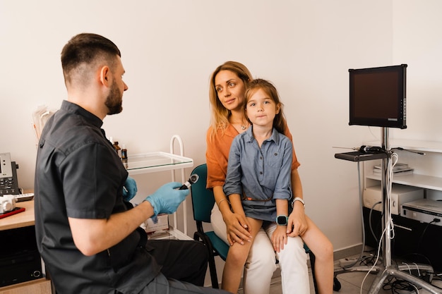 Family consultation daughter with mother with a pediatric otolaryngologist in a medical clinic Nose examination of the child