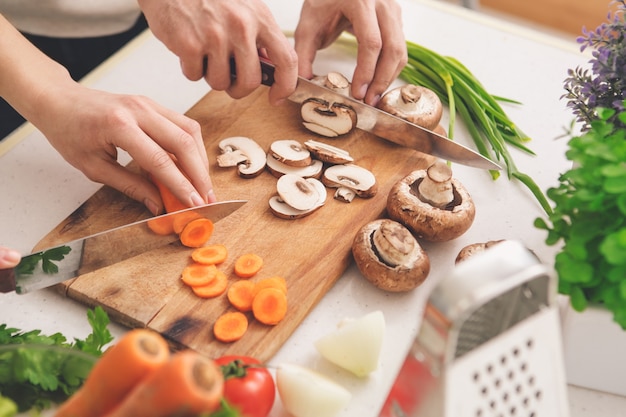 Family cooking meal preparation together cutting ingredients