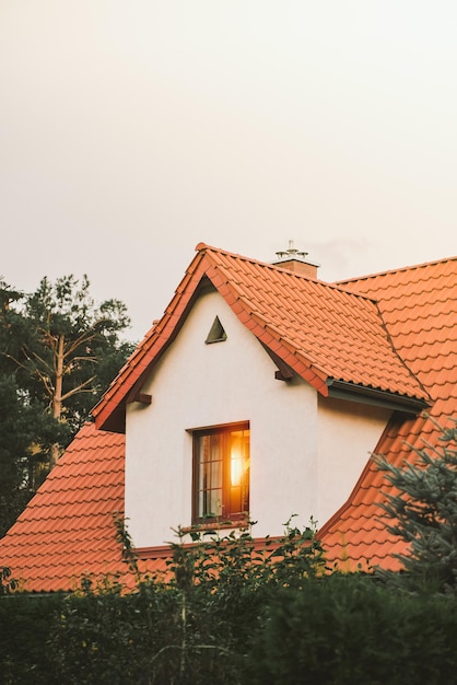 Family cottage against evening sky Close up of a house details windows roof and facade