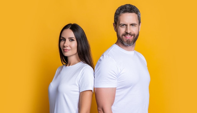 Photo family couple relationship millennial man and woman wearing white tshirt casual style of millennial couple boyfriend girlfriend couple of man and woman isolated on yellow friendship in couple