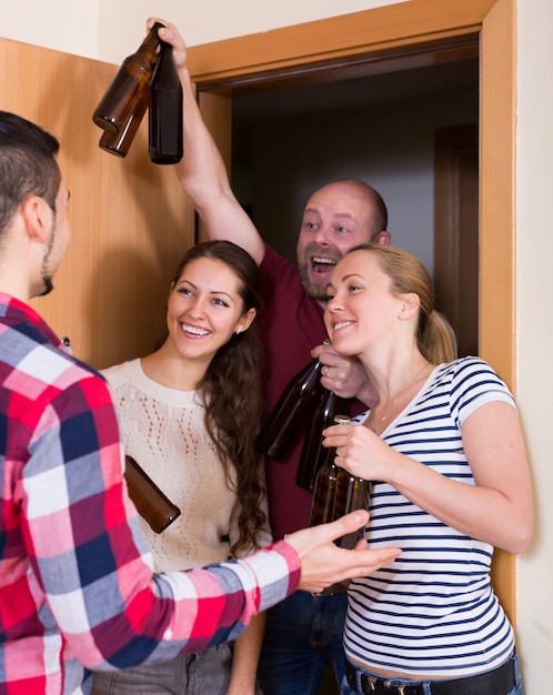  Family couple welcoming visitors at home