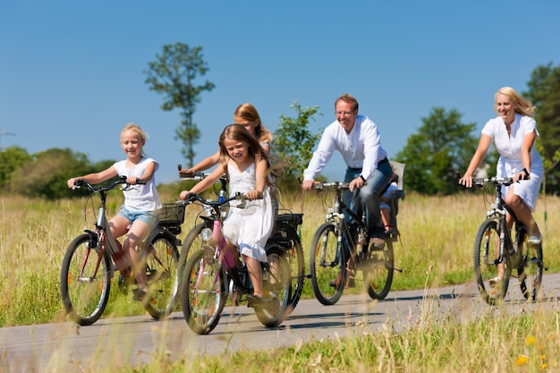 Family cycling outdoors in summer