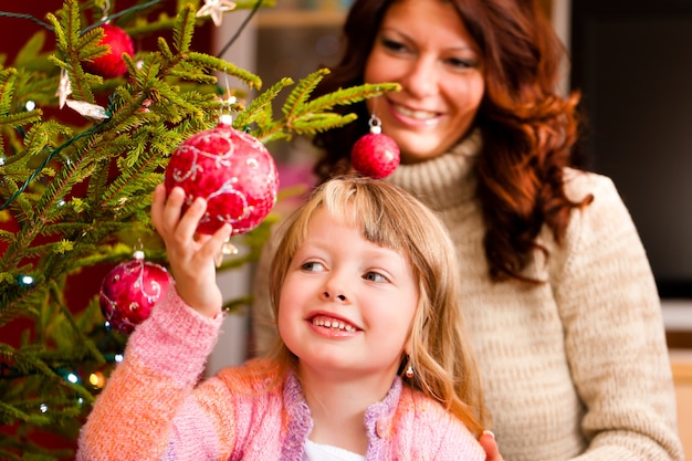 Family decorating Christmas tree