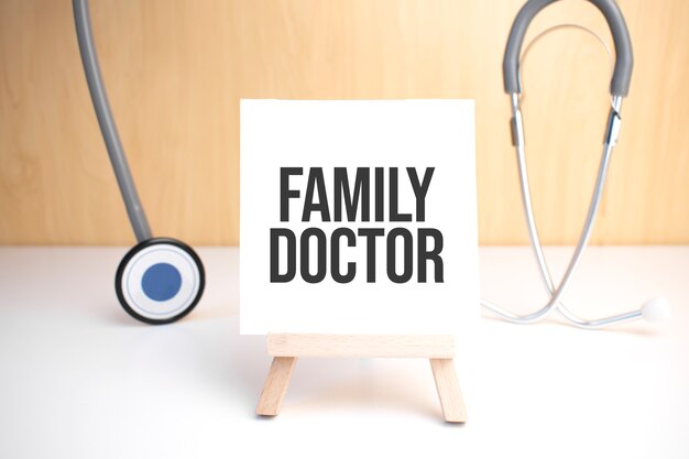 Family Doctor sign on small wood board rest on the easel with medical stethoscope