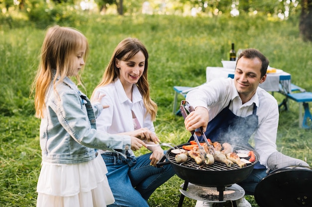 Family doing a barbecue in nature