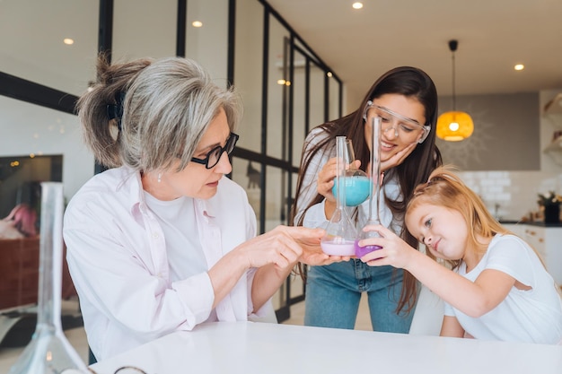 Family doing chemical experiment mixing flasks indoors