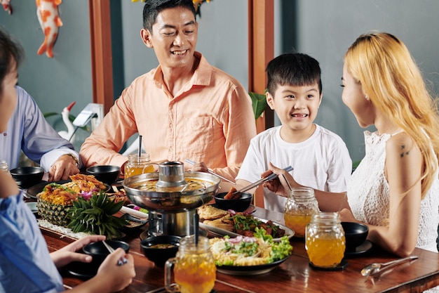 Family enjoying Asian cuisine at dinner