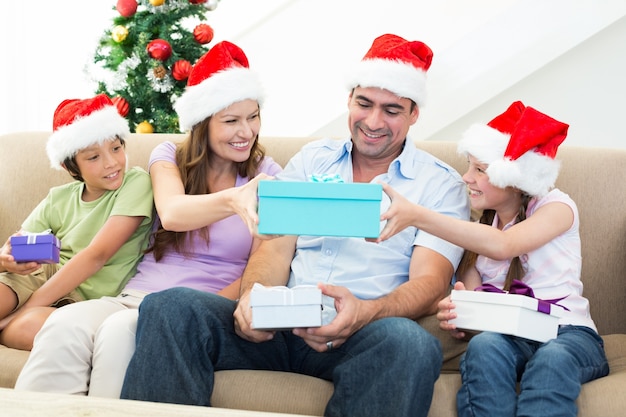 Family exchanging Christmas gifts