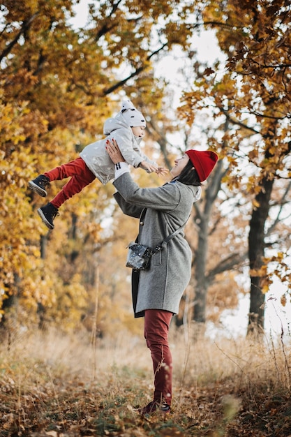 Family fall activities happy family mom and toddler baby girl playing outdoors in fall park