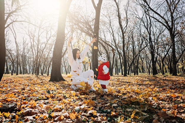 Family fall activities happy family mom and toddler baby girl playing outdoors in fall park