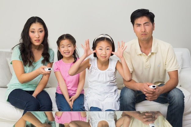 Family of four watching tv in the living room