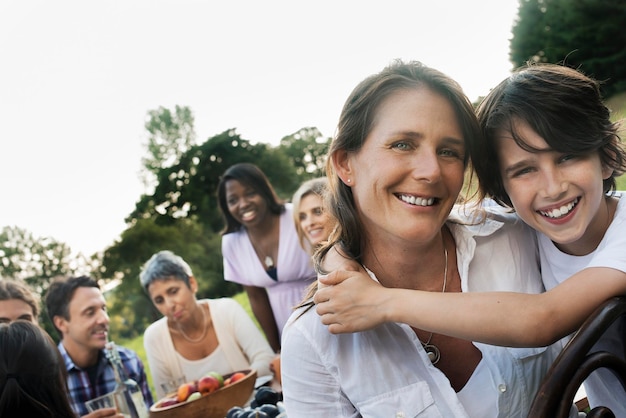 A family and friends having a meal outdoors A picnic or buffet in the early evening