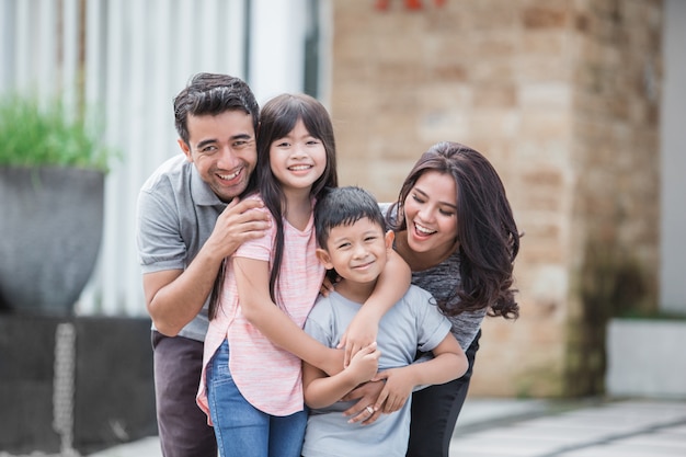 Family in front of their new house