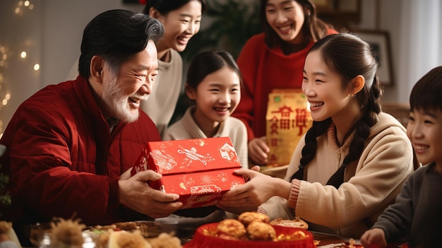 a family gathers around a table to give a gift to their parents.