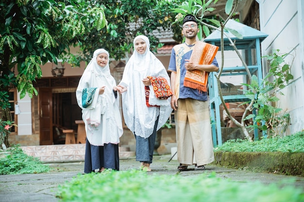 Family going to the mosque to do idul fitri or eid mubarak prayer