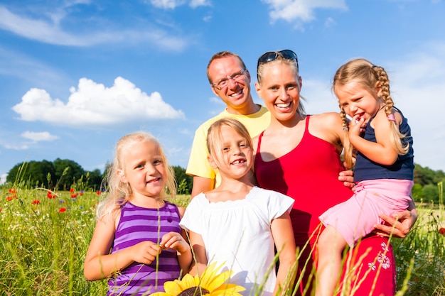 Family in grass in summer