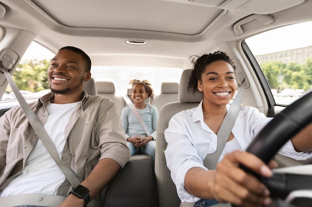 Family having car ride woman driving enjoying road trip