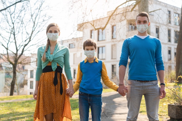 Family having a walk in the sun during coronavirus emergency