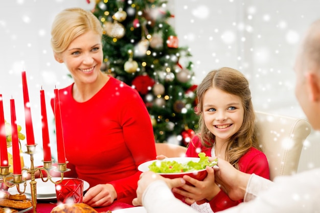 family, holidays, generation, christmas and people concept - smiling family having dinner at home