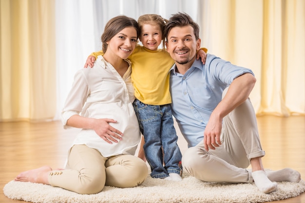 Family is looking at front and smiling.