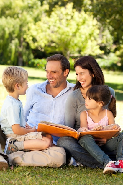 Family looking at their photo album in the park