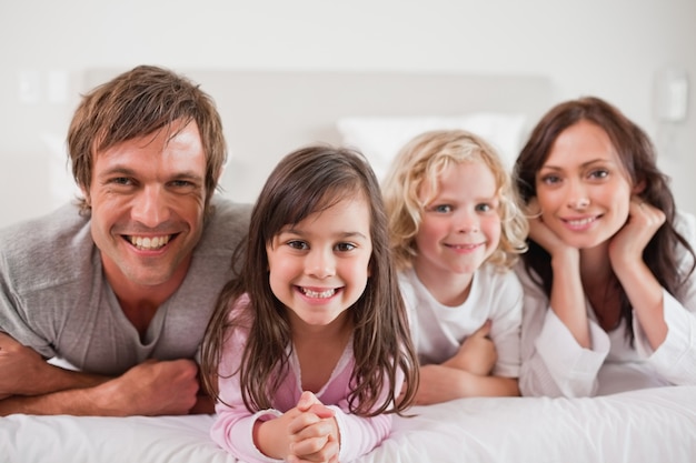 Family lying in a bed