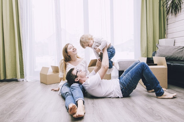 Family lying on the floor with boxes