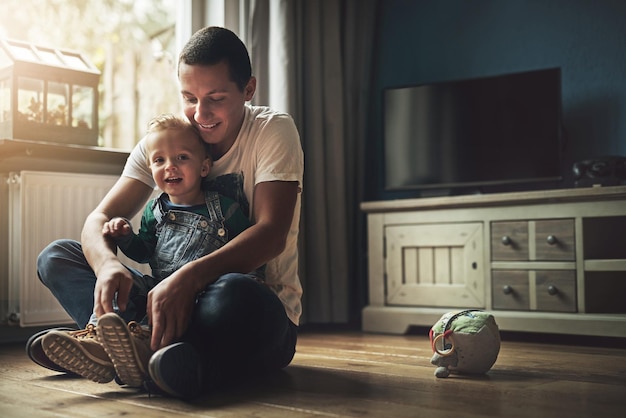 Family man and child in living room for love laugh and happiness in home together Dad young boy and smile for relationship care and play for development and fun in lounge for bonding or relax