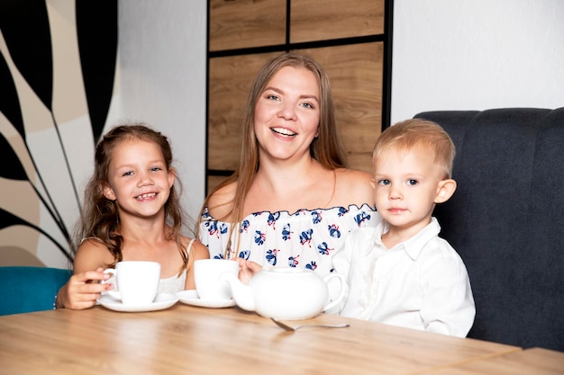 Family mother and children in a cafe Spending time with children Happy