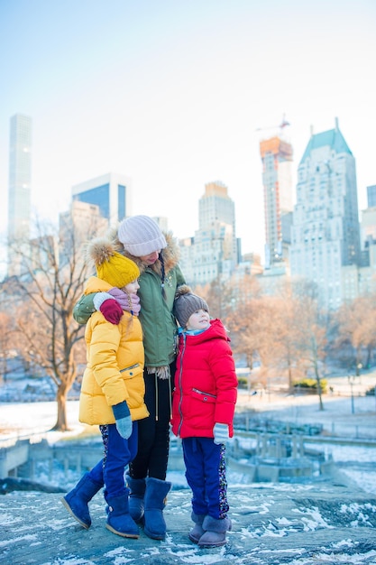 Family of mother and kids in central park during their vacation in new york city