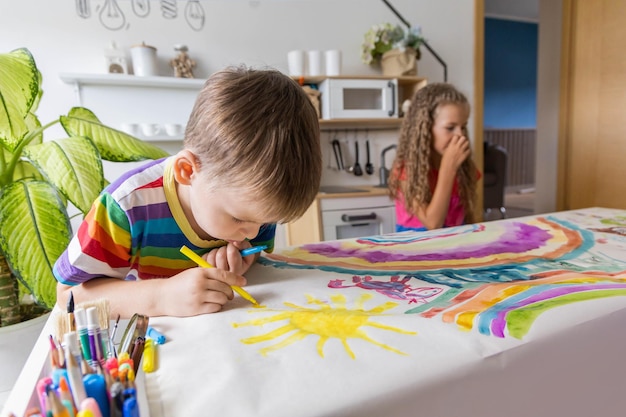 Photo family mother and kids drawing art picture on paper with multicolored chalks enjoy weekend