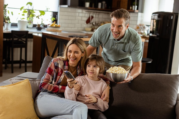 Family Movie Night Engrossed in Thrilling Scenes at Home