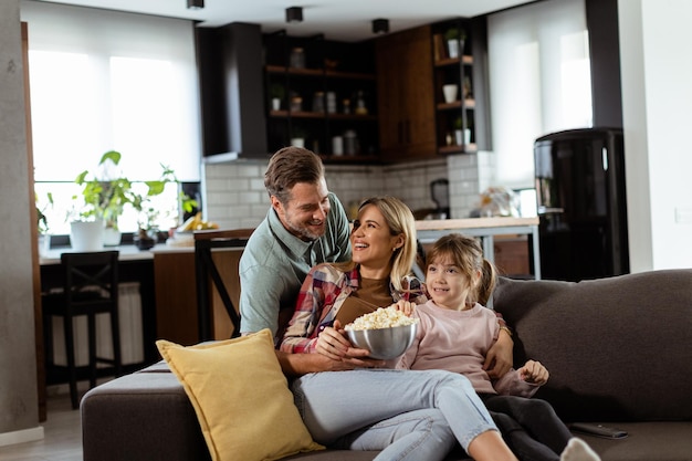 Family Movie Night Engrossed in Thrilling Scenes at Home