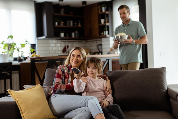 Family Movie Night Engrossed in Thrilling Scenes at Home