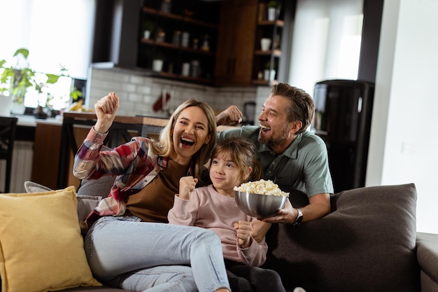 Family Movie Night Engrossed in Thrilling Scenes at Home