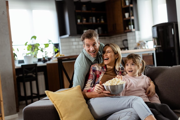 Family Movie Night Engrossed in Thrilling Scenes at Home