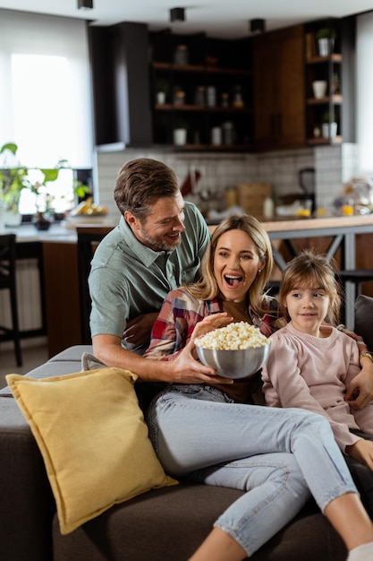 Family Movie Night Engrossed in Thrilling Scenes at Home