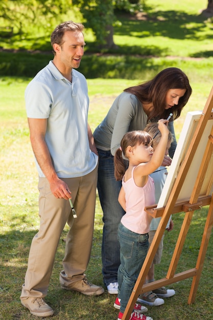 Family painting together in the park