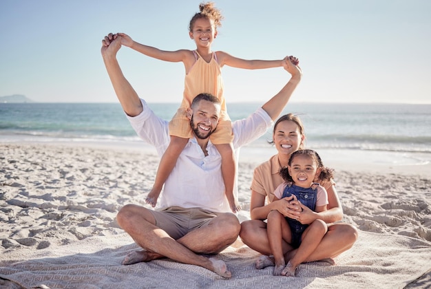 Family parents and children bonding on beach in fun play and happy picnic by sea or ocean in Colombia Portrait smile and relax man and woman with girls kids and security trust on summer holiday