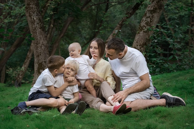 Family picnic outdoors Mum dad and three children spend quality time together