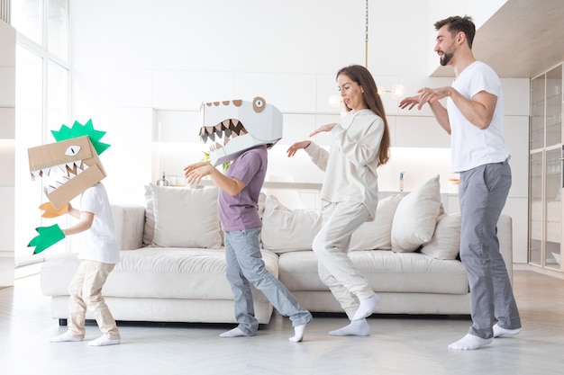 Family playing dinosaurs at home